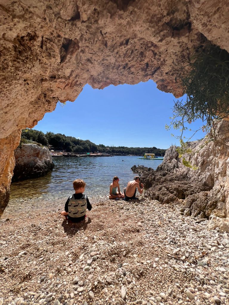 Children enjoying a private beach on an island in Croatia at a luxury family campsite.