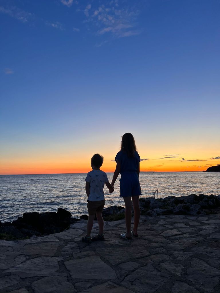 Family enjoying a sunset on the Istrian Coast of Croatia near Porec.