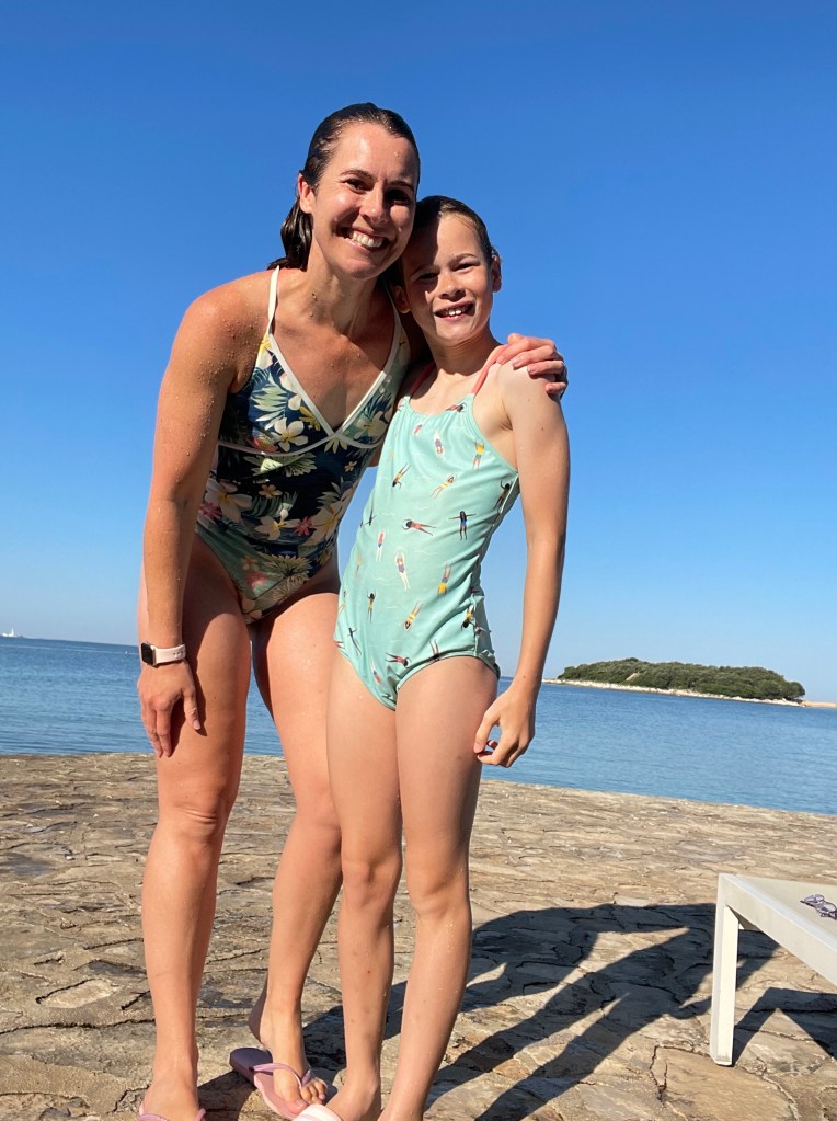 mother and daughter early morning swim in Croatia at luxury European campsite