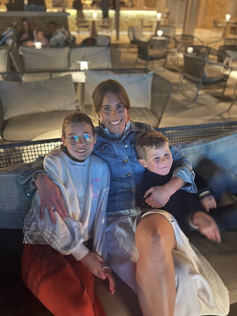 Happy family enjoying the eveneing entertainment at Ikos Olivia